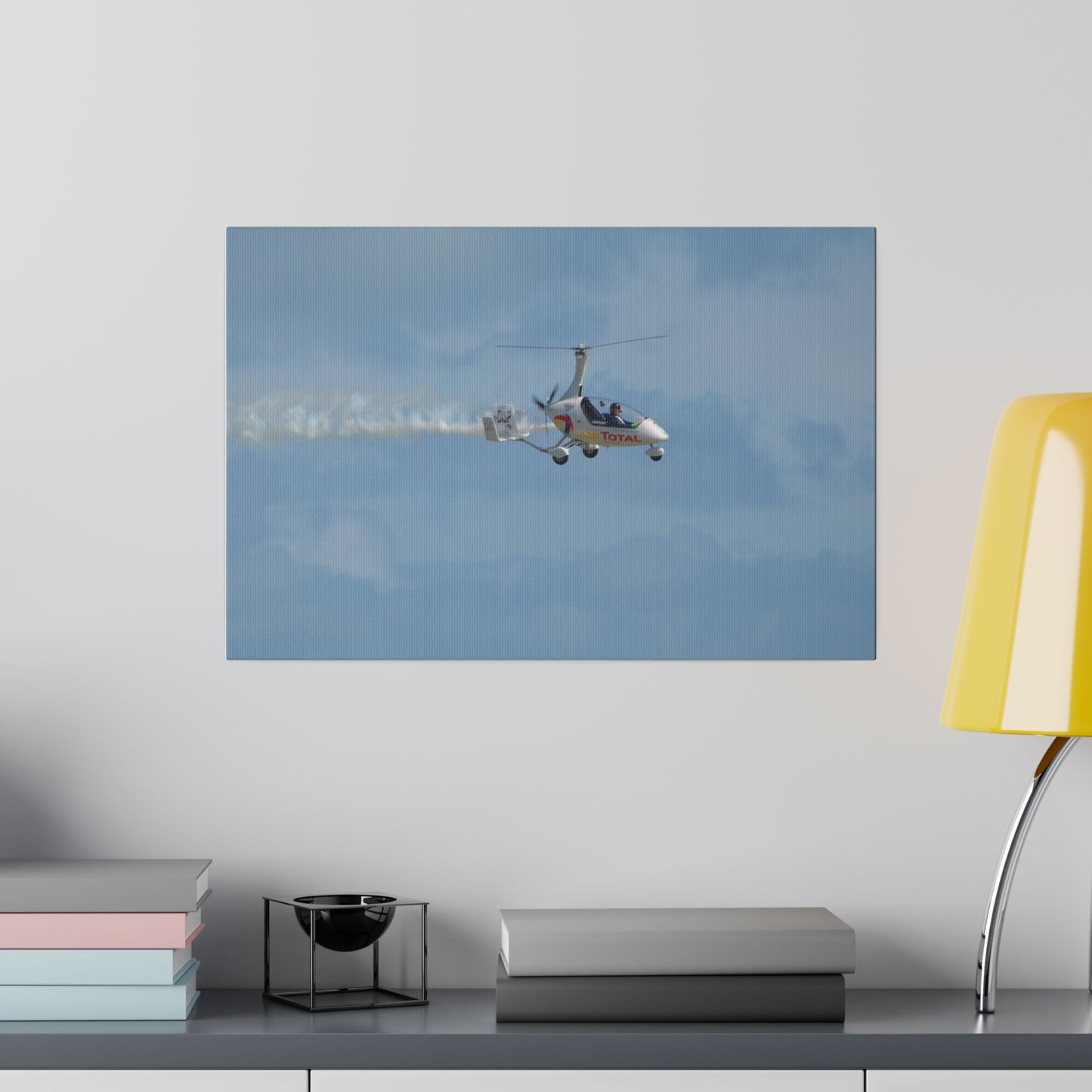 AutoGyro Flying From The Left With Smoke, Pilot Looking Over Canvas - The Trio Synergize Group