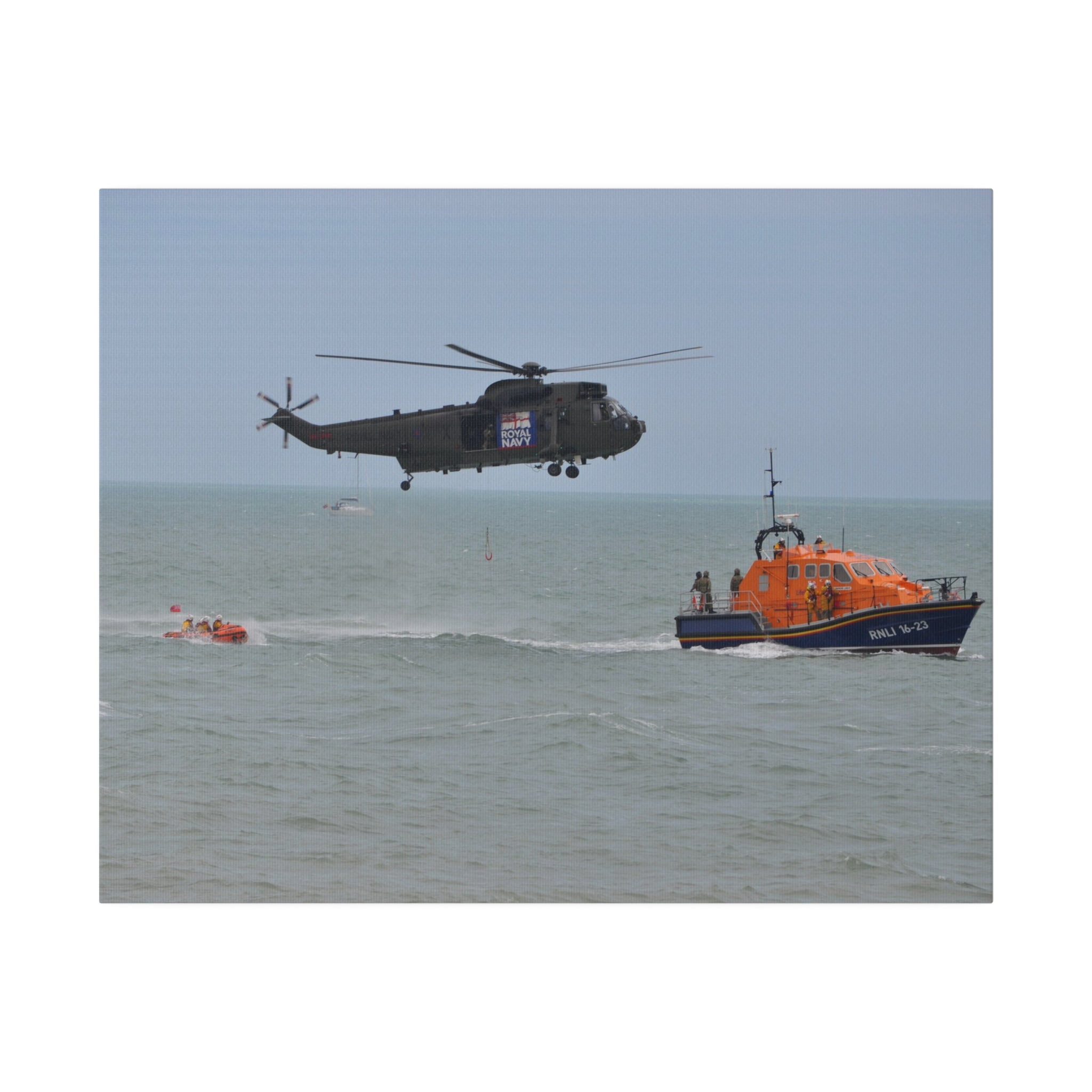 Sea King Helicopter Lowers Winch near RNLI Lifeboats Canvas - The Trio Synergize Group