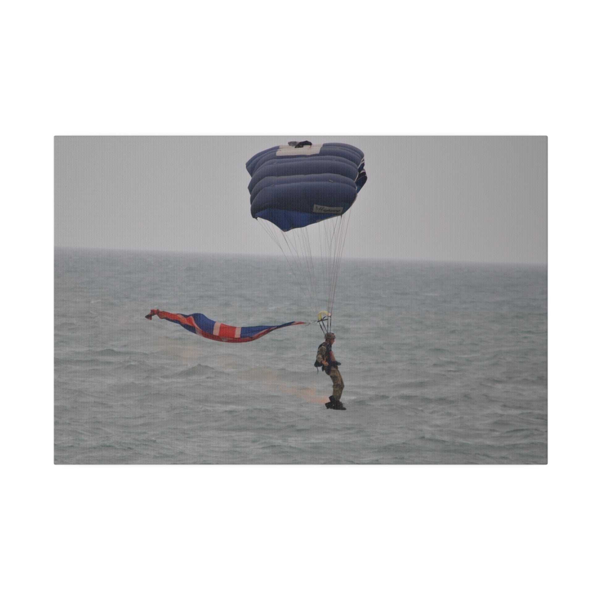Parachuter With Flag And Smoke Just Above The Sea Canvas - The Trio Synergize Group