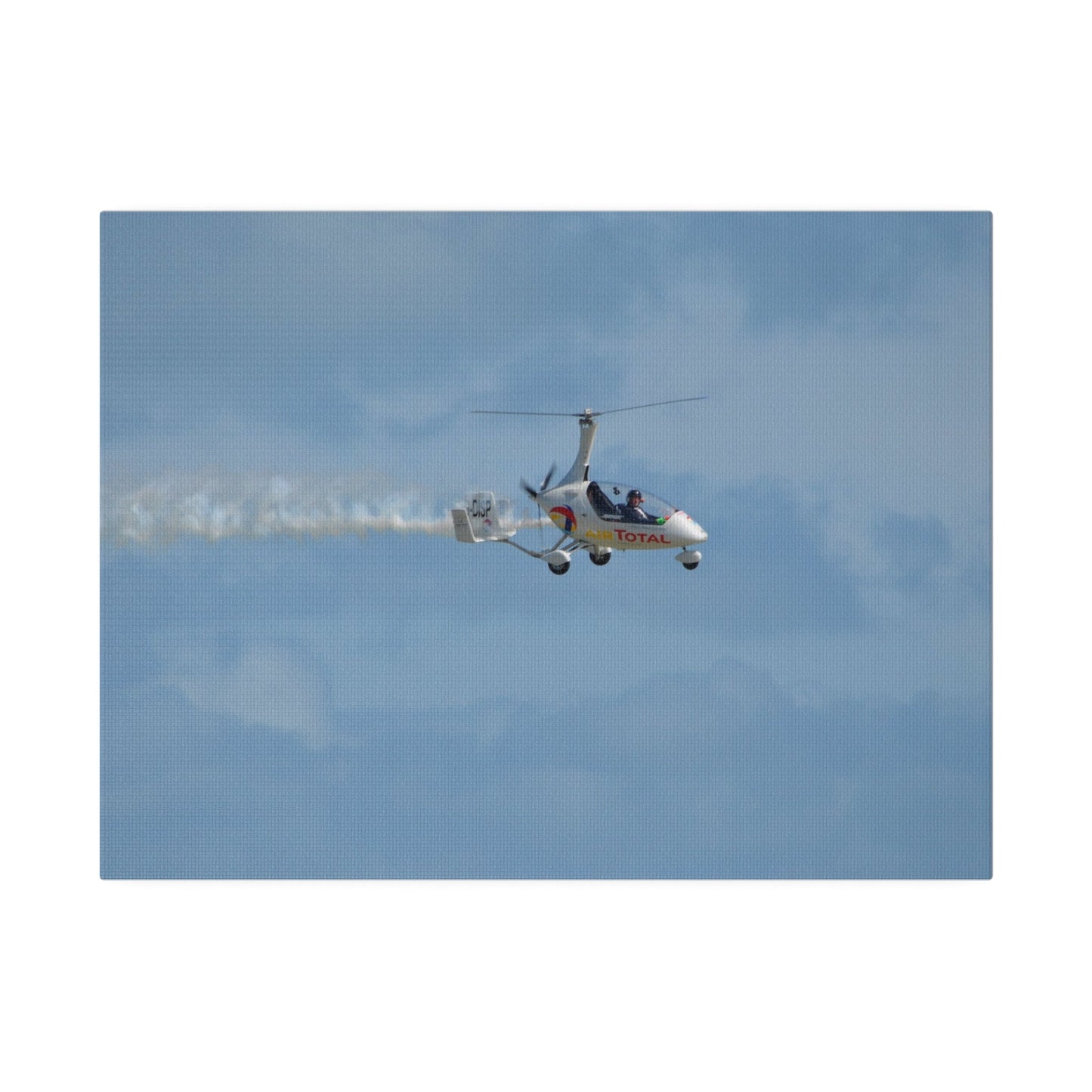 AutoGyro Flying From The Left With Smoke, Pilot Looking Over, Matte Canvas, Stretched, 0.75" - The Trio Synergize Group