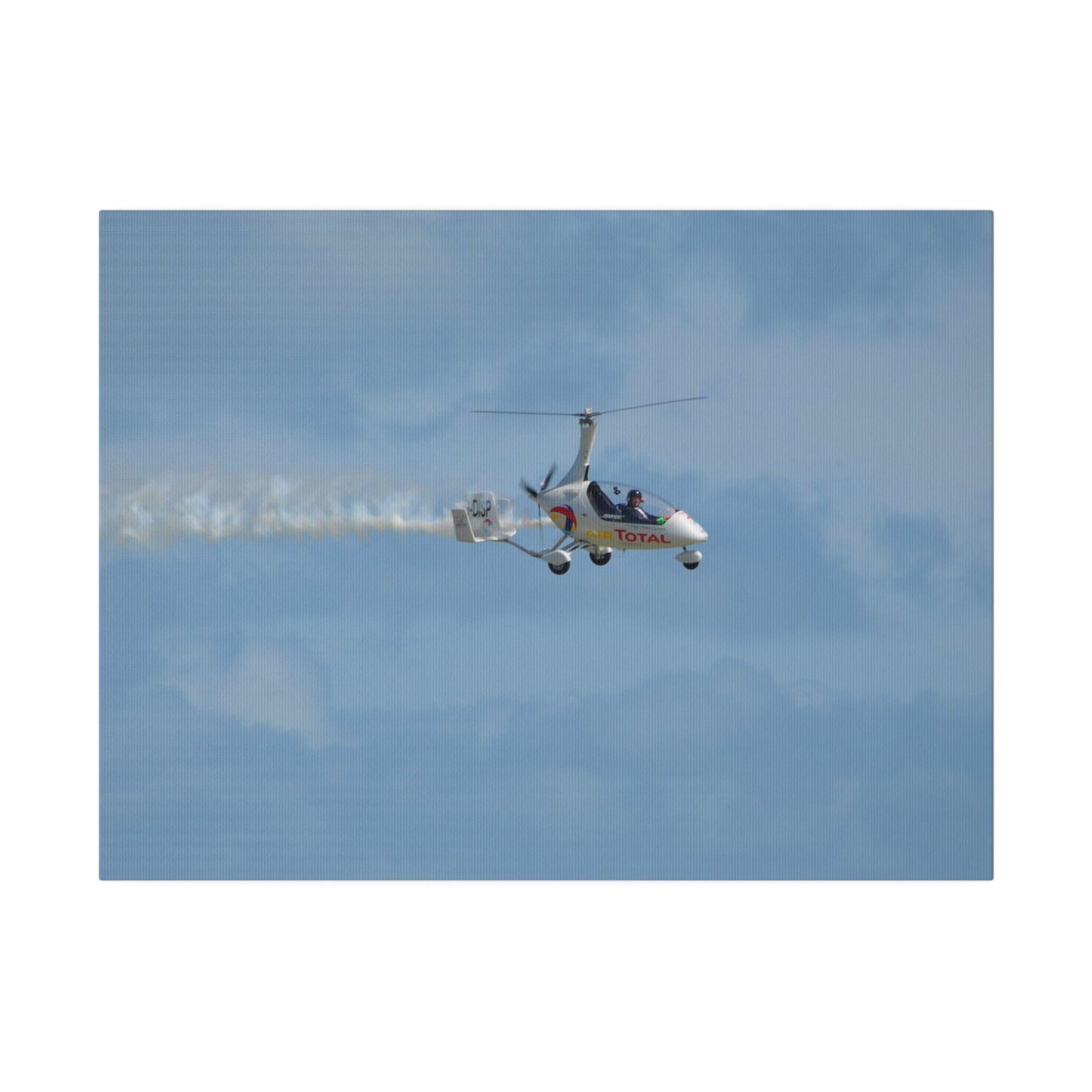 AutoGyro Flying From The Left With Smoke, Pilot Looking Over, Matte Canvas, Stretched, 0.75" - The Trio Synergize Group