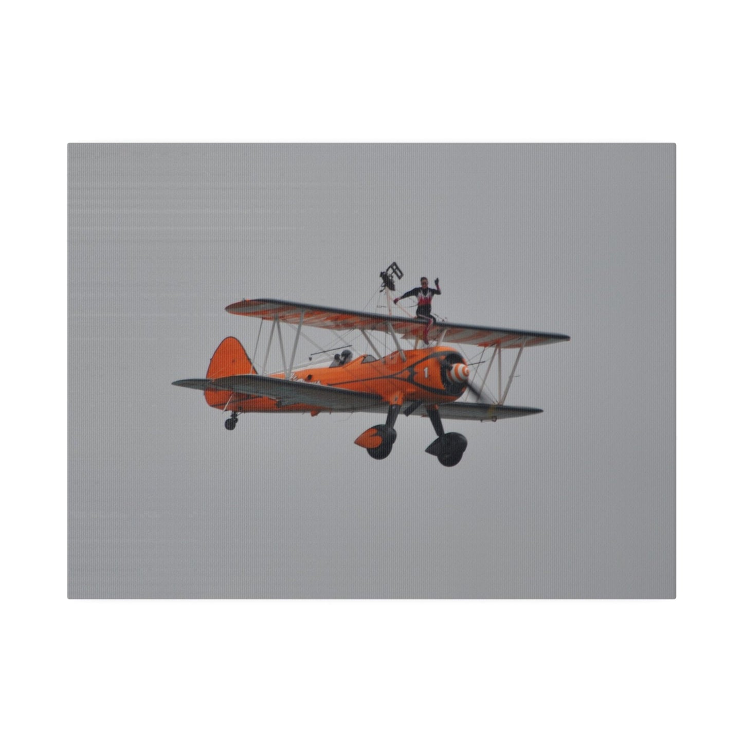 Single Wing Walker Flying From The Left, Front View Much Closer, Person Sitting On The Wing Without The Harness Looking Towards Us, Matte Canvas, Stretched, 0.75" - The Trio Synergize Group