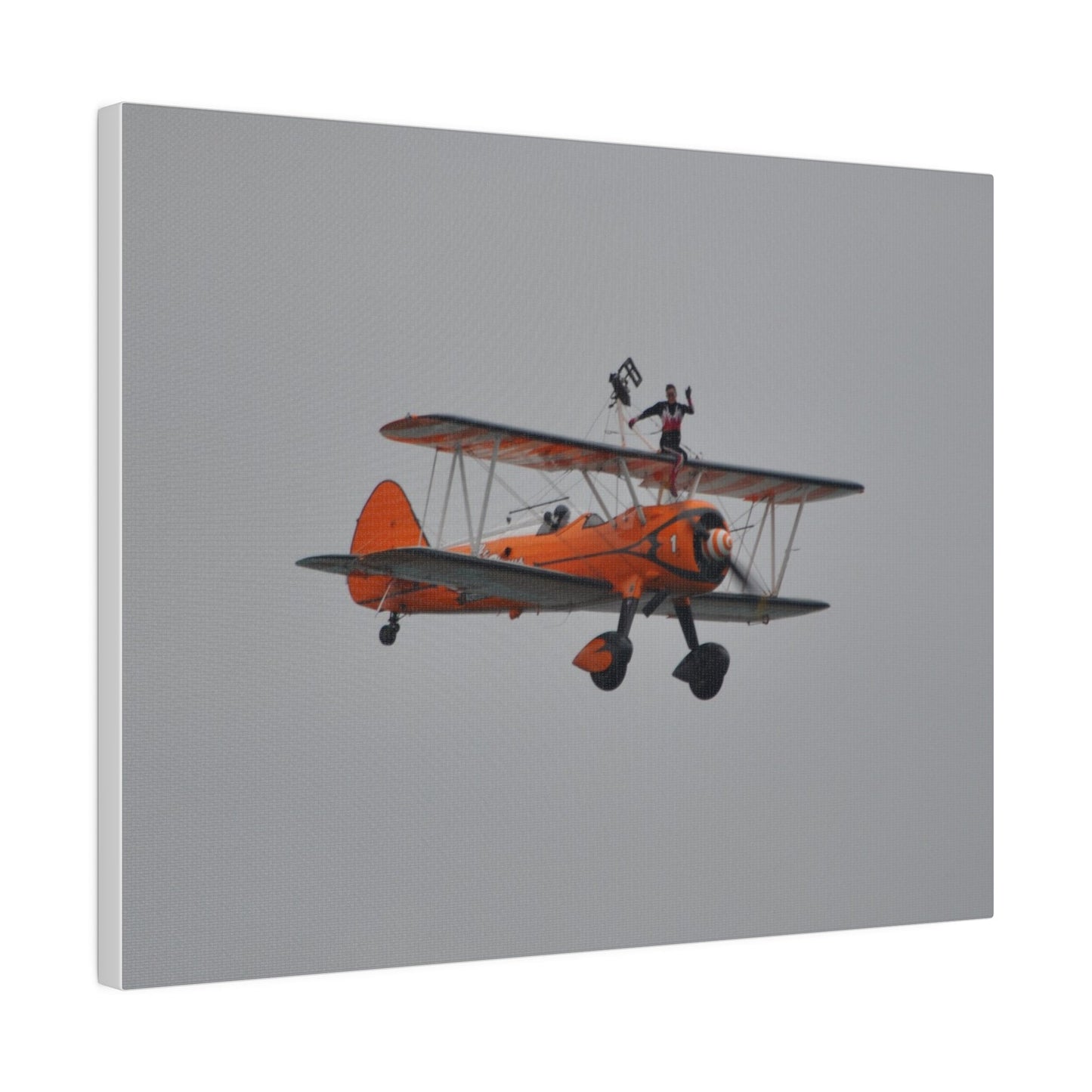 Single Wing Walker Flying From The Left, Front View Much Closer, Person Sitting On The Wing Without The Harness Looking Towards Us, Matte Canvas, Stretched, 0.75" - The Trio Synergize Group