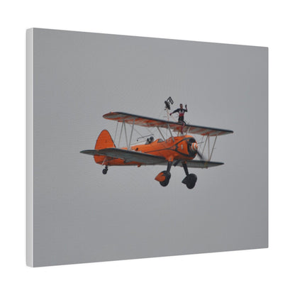 Single Wing Walker Flying From The Left, Front View Much Closer, Person Sitting On The Wing Without The Harness Looking Towards Us, Matte Canvas, Stretched, 0.75" - The Trio Synergize Group