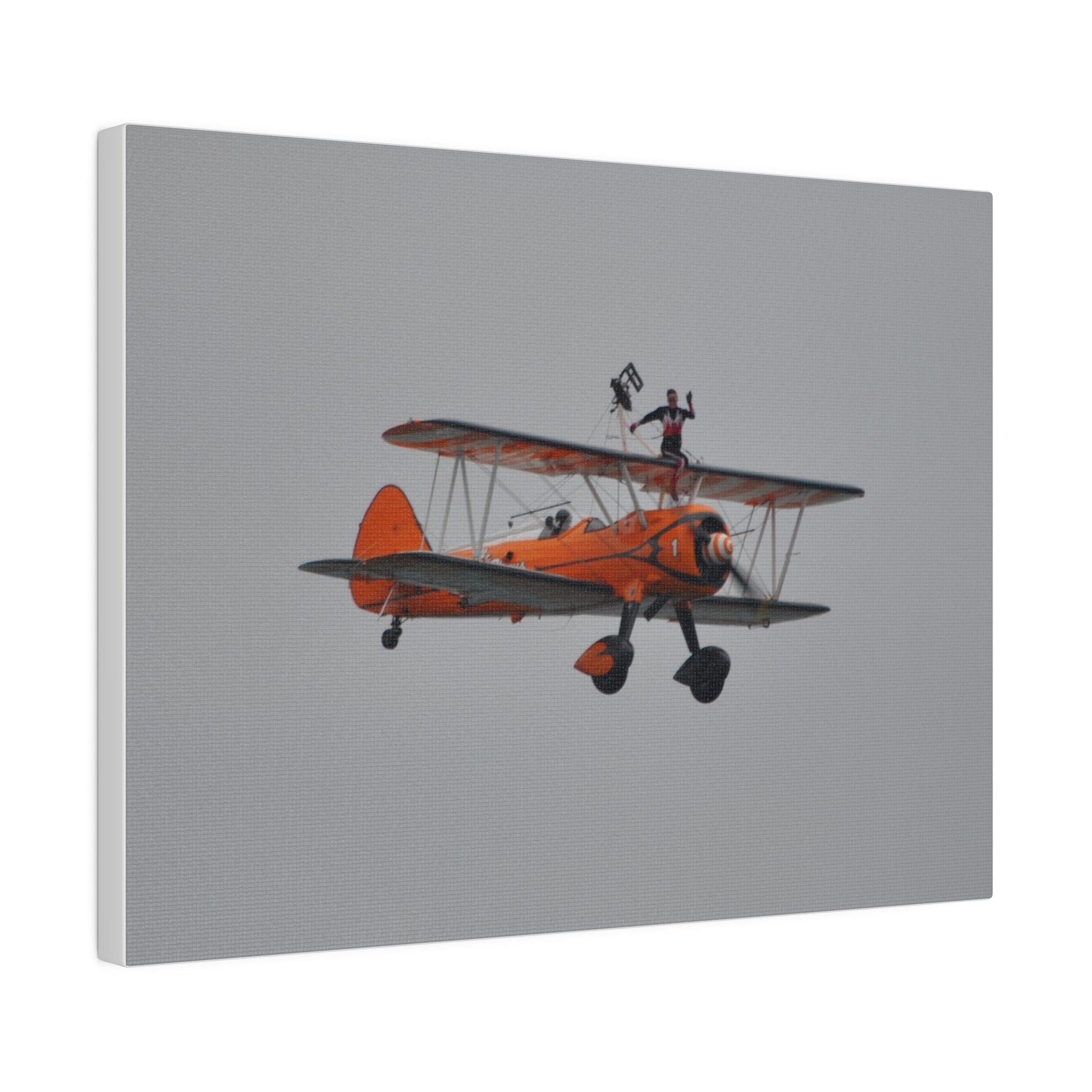 Single Wing Walker Flying From The Left, Front View Much Closer, Person Sitting On The Wing Without The Harness Looking Towards Us, Matte Canvas, Stretched, 0.75" - The Trio Synergize Group