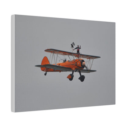 Single Wing Walker Flying From The Left, Front View Much Closer, Person Sitting On The Wing Without The Harness Looking Towards Us, Matte Canvas, Stretched, 0.75" - The Trio Synergize Group