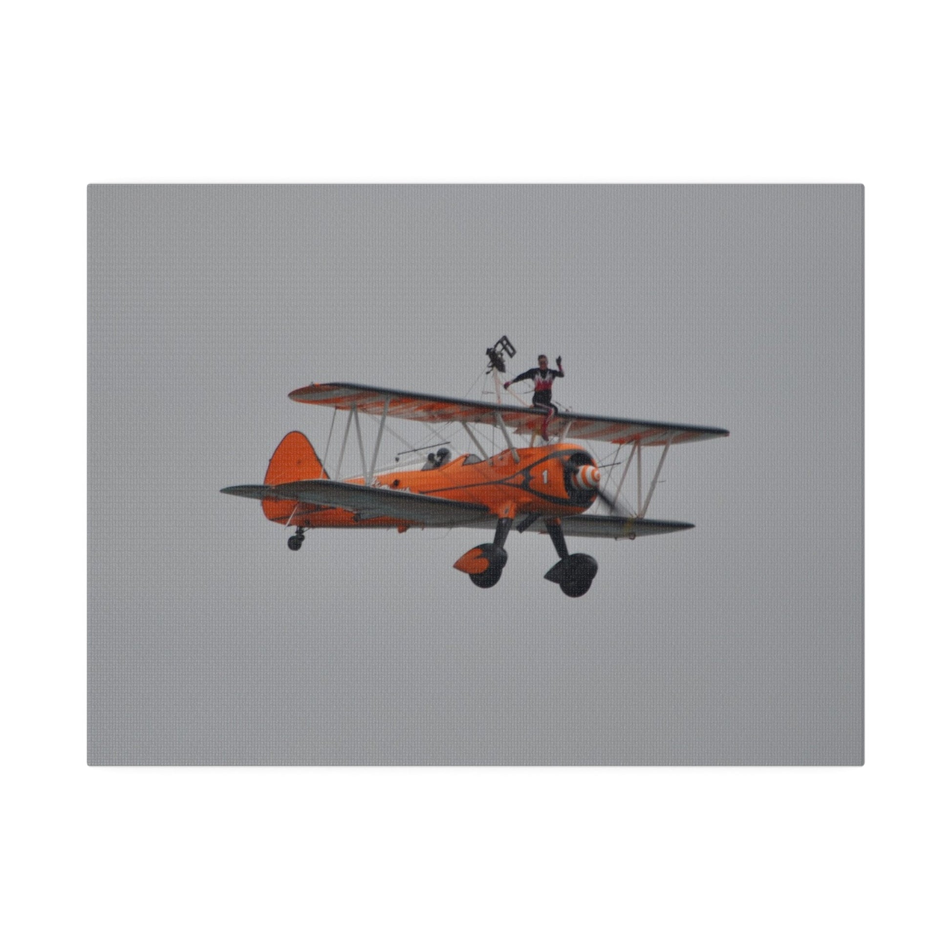 Single Wing Walker Flying From The Left, Front View Much Closer, Person Sitting On The Wing Without The Harness Looking Towards Us, Matte Canvas, Stretched, 0.75" - The Trio Synergize Group