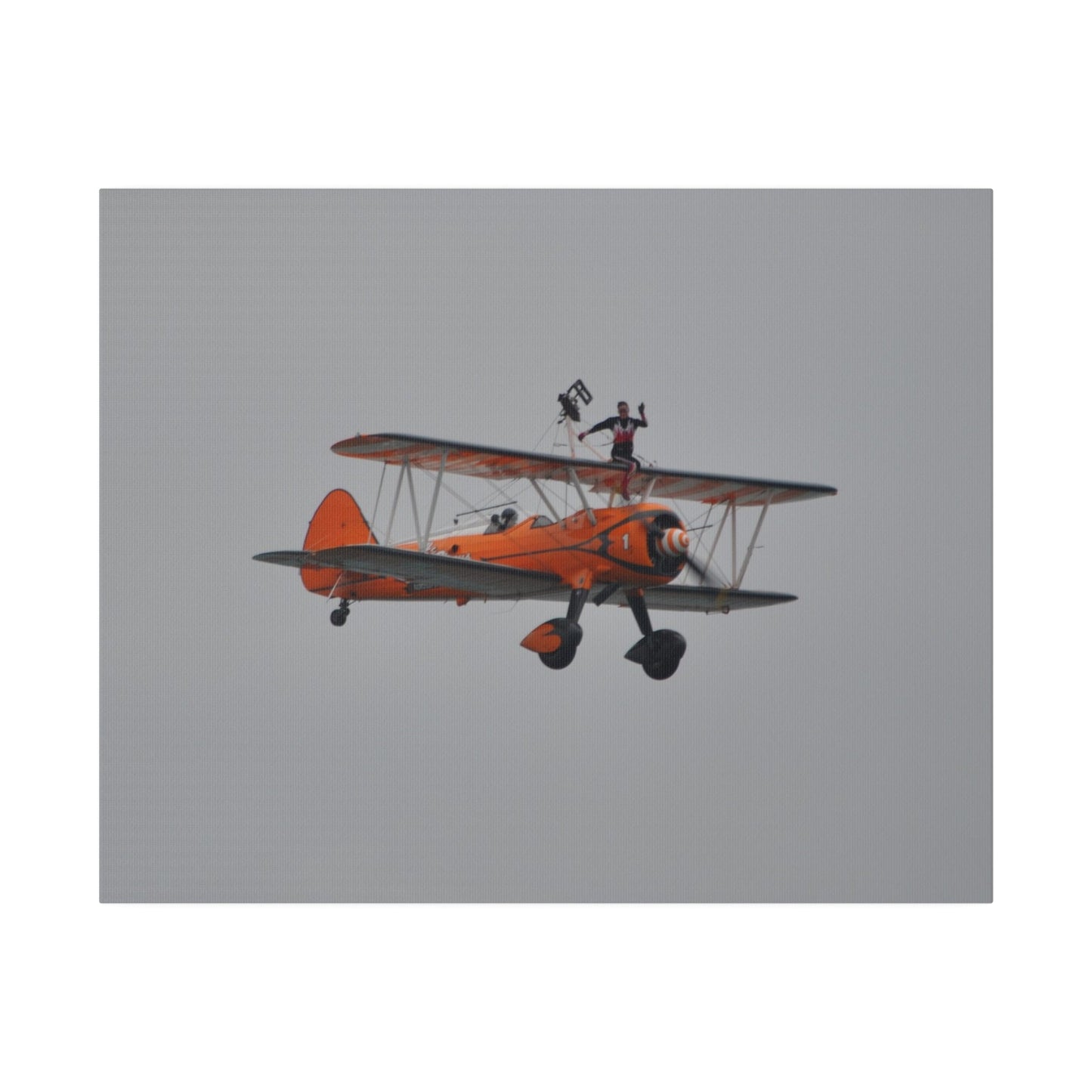 Single Wing Walker Flying From The Left, Front View Much Closer, Person Sitting On The Wing Without The Harness Looking Towards Us, Matte Canvas, Stretched, 0.75" - The Trio Synergize Group