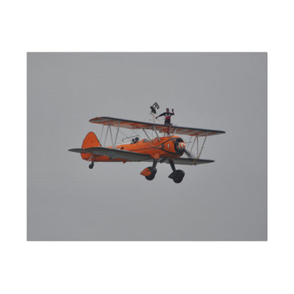 Single Wing Walker Flying From The Left, Front View Much Closer, Person Sitting On The Wing Without The Harness Looking Towards Us, Matte Canvas, Stretched, 0.75" - The Trio Synergize Group
