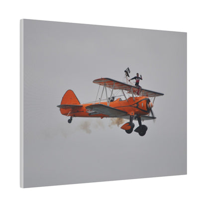 Single Wing Walker Flying From The Left, Front View Much Closer, Person Sitting On The Wing Without The Harness Looking Towards Us With Smoke, Matte Canvas, Stretched, 0.75" - The Trio Synergize Group