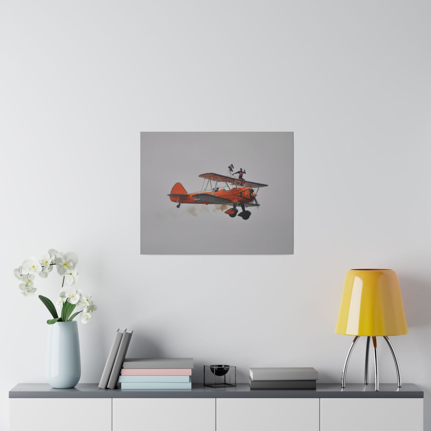 Single Wing Walker Flying From The Left, Front View Much Closer, Person Sitting On The Wing Without The Harness Looking Towards Us With Smoke, Matte Canvas, Stretched, 0.75" - The Trio Synergize Group