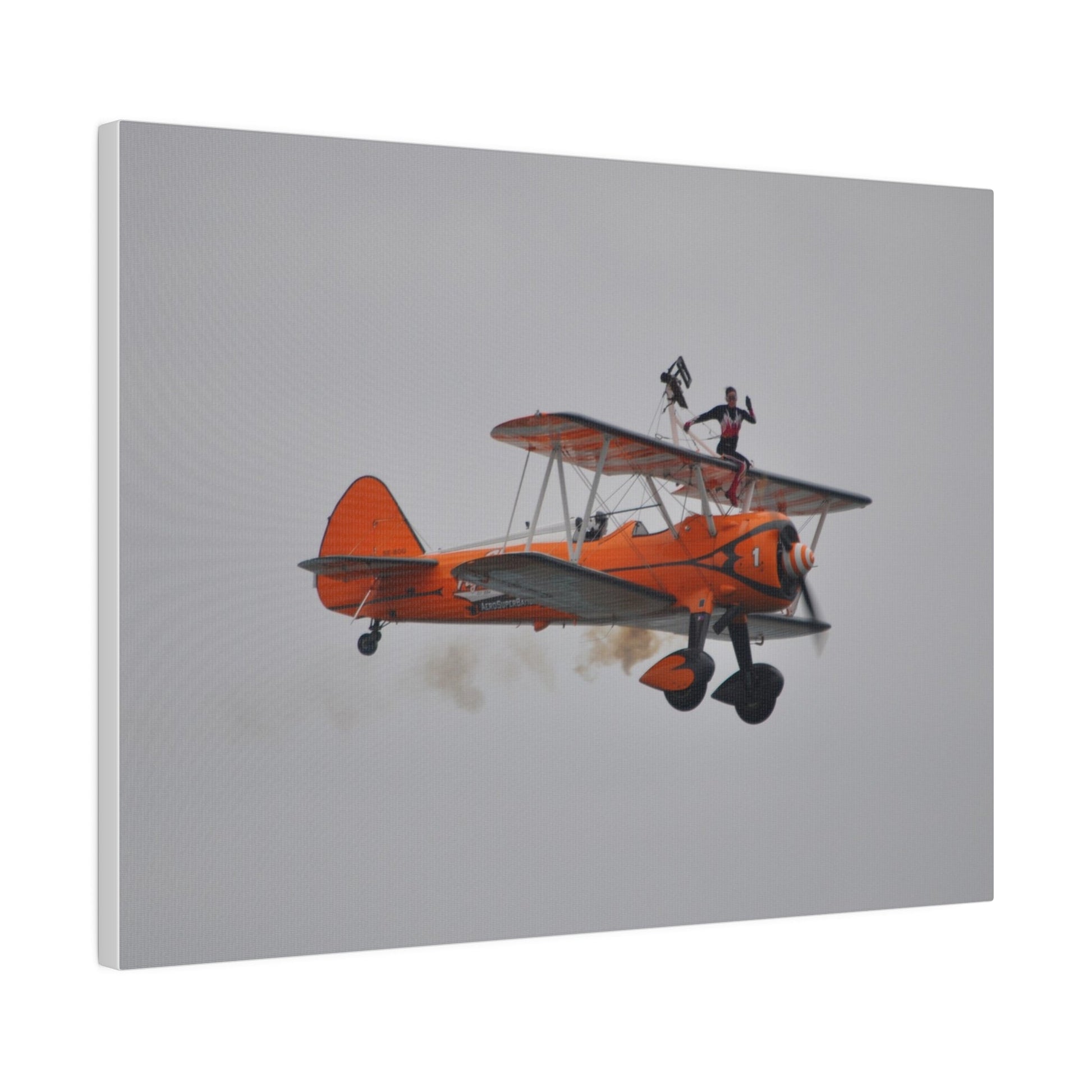 Single Wing Walker Flying From The Left, Front View Much Closer, Person Sitting On The Wing Without The Harness Looking Towards Us With Smoke, Matte Canvas, Stretched, 0.75" - The Trio Synergize Group