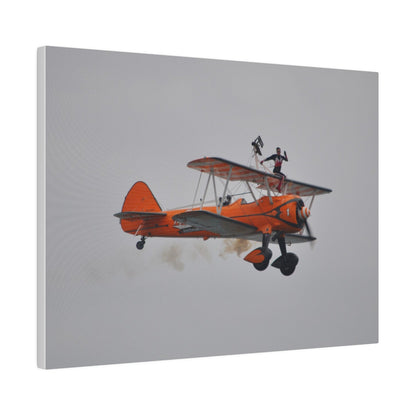 Single Wing Walker Flying From The Left, Front View Much Closer, Person Sitting On The Wing Without The Harness Looking Towards Us With Smoke, Matte Canvas, Stretched, 0.75" - The Trio Synergize Group