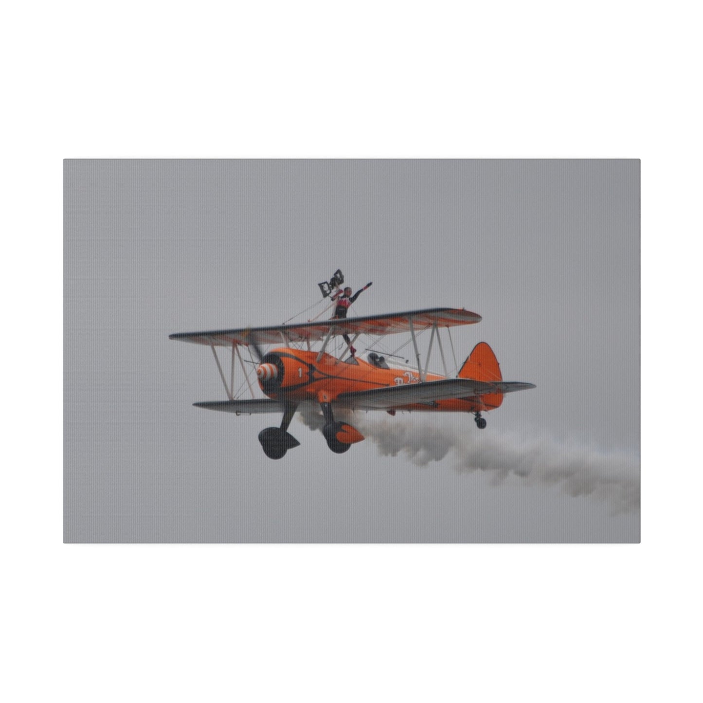 Single Wing Walker Flying From The Right, Front Side View Much Closer Up, Person Standing Without The Harness With Left Arm Out, With Smoke, Matte Canvas, Stretched, 0.75" - The Trio Synergize Group