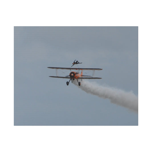 The Wing Walker Flying Straight Forward With Smoke Canvas - The Trio Synergize Group